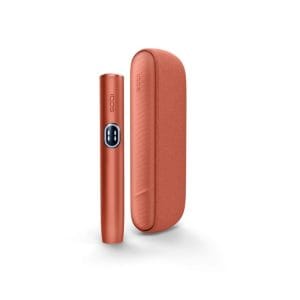 Adult user operating the buy IQOS ILUMA i Standard Orange UAE device showing the Vivid Terracotta holder and pocket charger